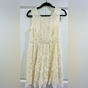 Cream dress with exposed zipper back.